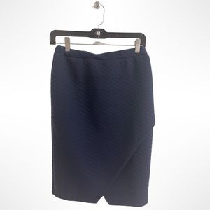 Navy blue quilted pencil with asymmetrical detailing.